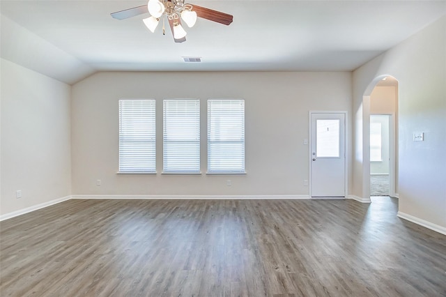 spare room featuring dark hardwood / wood-style flooring, ceiling fan, and a healthy amount of sunlight