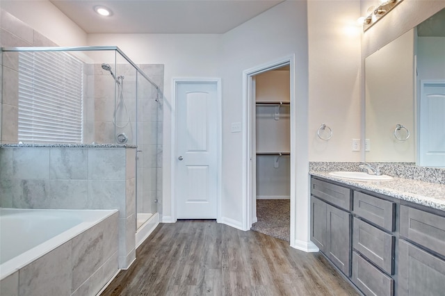 bathroom featuring vanity, independent shower and bath, and hardwood / wood-style floors