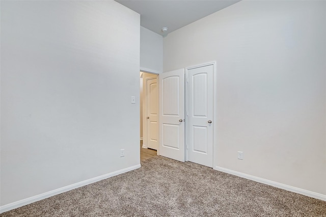 unfurnished room featuring light colored carpet