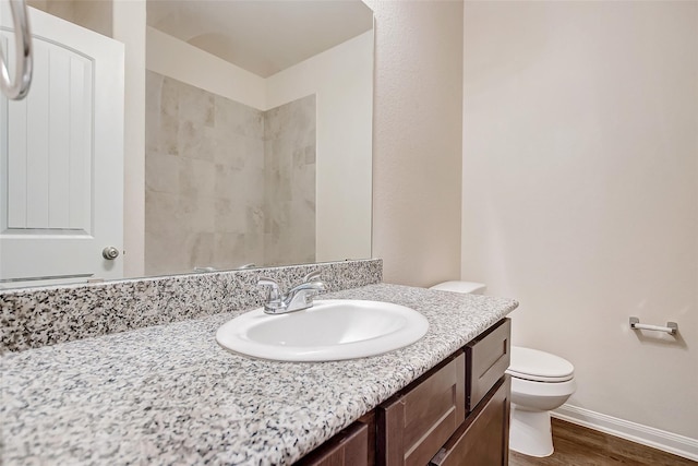 bathroom with vanity, hardwood / wood-style floors, and toilet