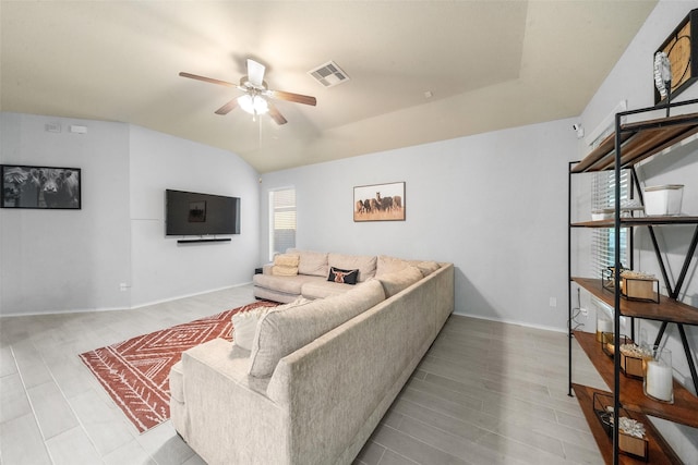 living room with lofted ceiling, light hardwood / wood-style floors, and ceiling fan