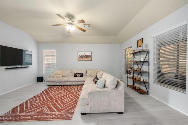 living room featuring vaulted ceiling and ceiling fan