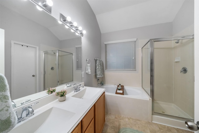 bathroom with lofted ceiling, vanity, and plus walk in shower