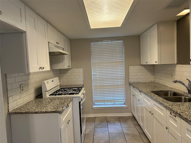 kitchen featuring white cabinetry, sink, white gas stove, and light stone counters