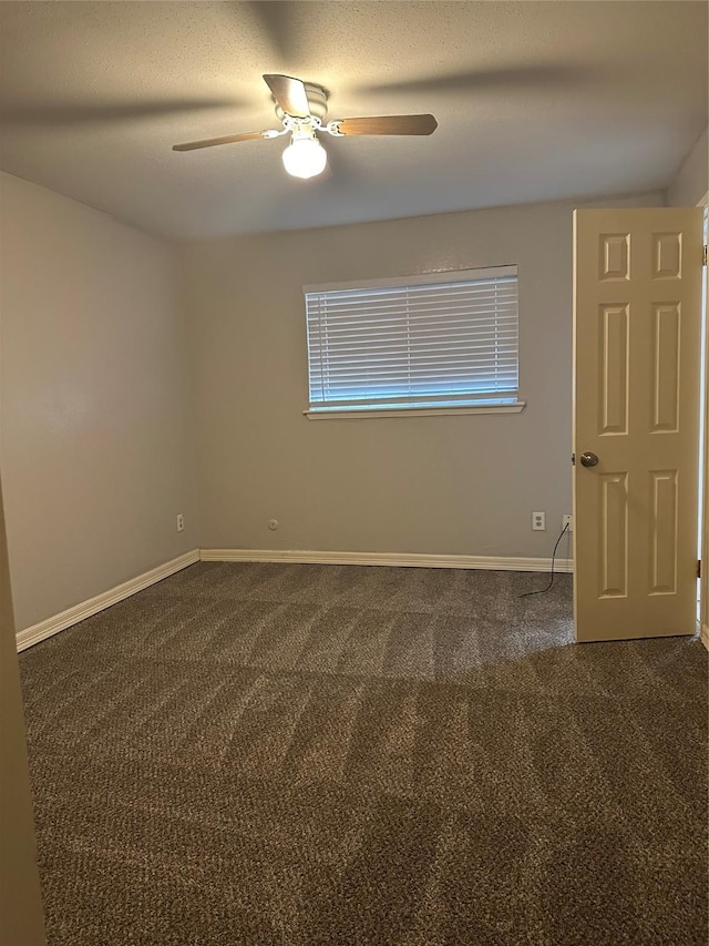 carpeted spare room with ceiling fan and a textured ceiling