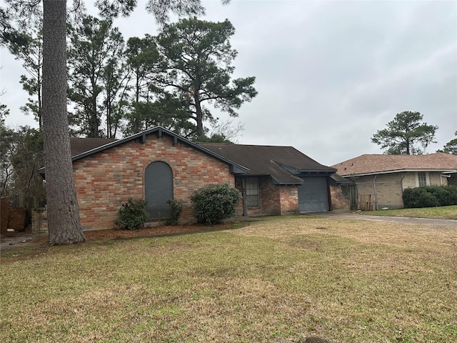 ranch-style house with a garage and a front yard