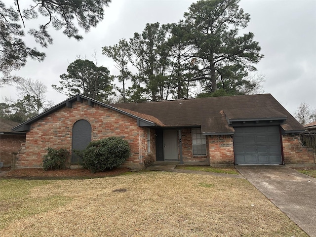 ranch-style home with a garage and a front yard