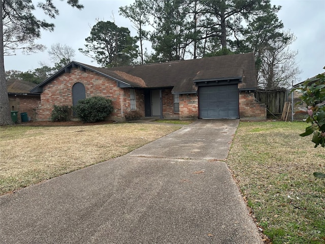 ranch-style home with a garage and a front yard