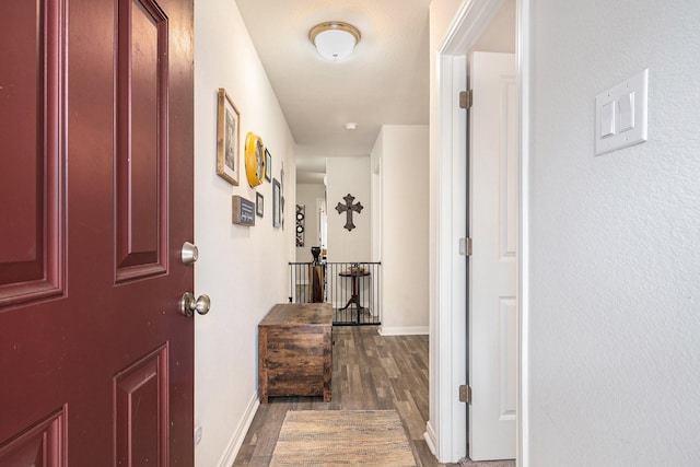 corridor with dark hardwood / wood-style flooring