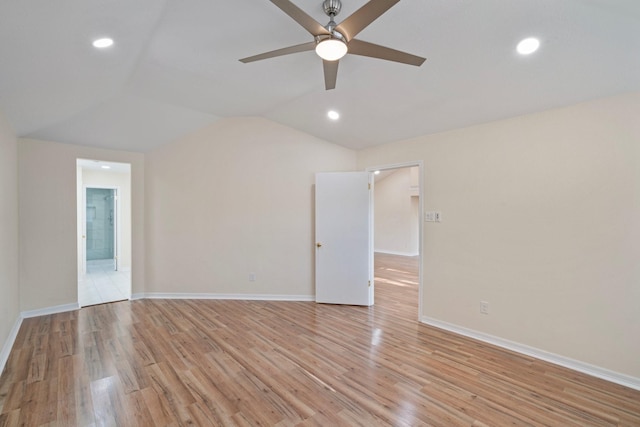 unfurnished room with vaulted ceiling, ceiling fan, and light hardwood / wood-style floors