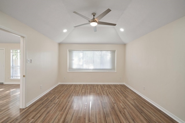 spare room with wood-type flooring, vaulted ceiling, and ceiling fan