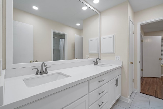 bathroom with tile patterned floors and vanity