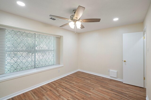 empty room featuring hardwood / wood-style floors and ceiling fan