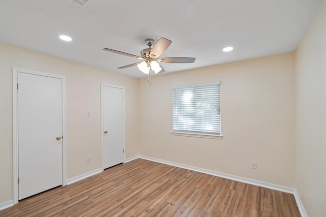 unfurnished bedroom featuring ceiling fan and light wood-type flooring