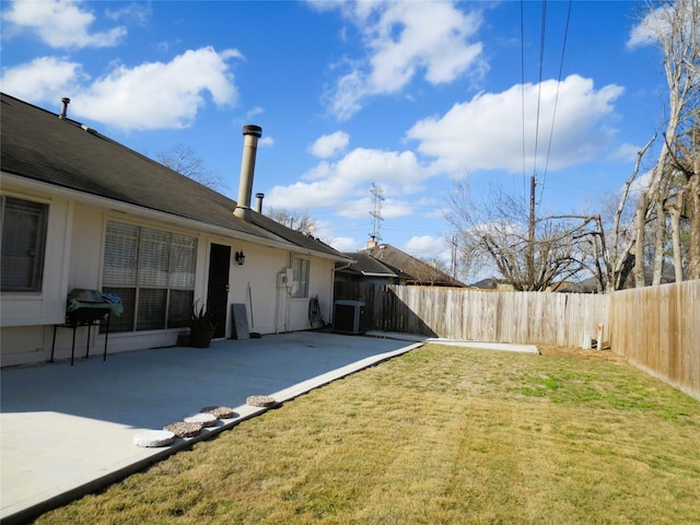 view of yard with central AC unit and a patio area