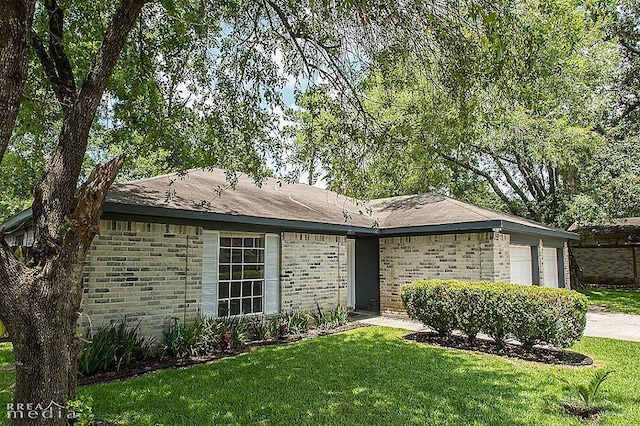 single story home with a garage and a front yard