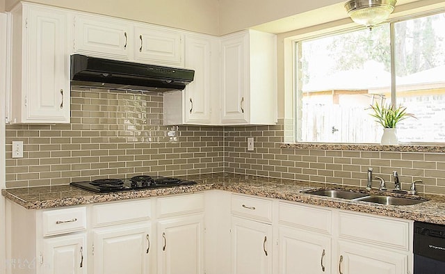 kitchen featuring tasteful backsplash, sink, white cabinets, and black appliances