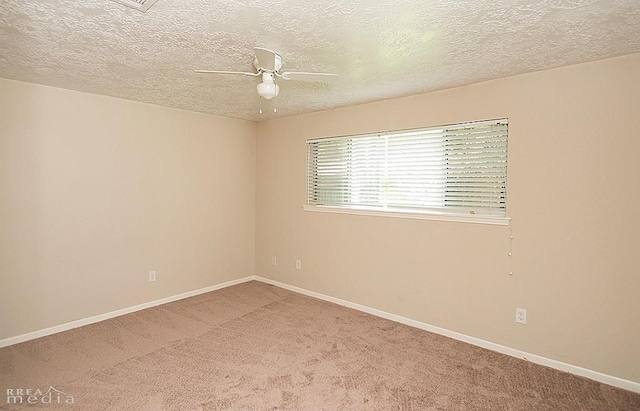 spare room featuring a textured ceiling, ceiling fan, and carpet flooring