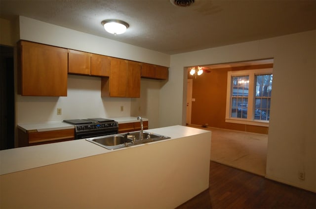 kitchen featuring dark wood-type flooring, black electric range oven, sink, and a textured ceiling