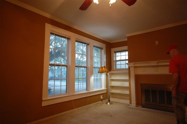 living room featuring crown molding, carpet floors, and ceiling fan