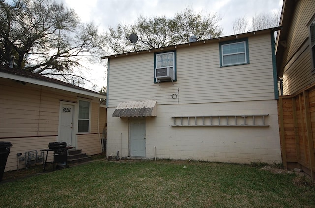 back of house featuring cooling unit and a lawn