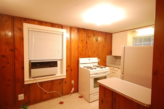 kitchen with cooling unit, white appliances, and wood walls