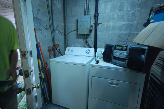 clothes washing area featuring washer and clothes dryer