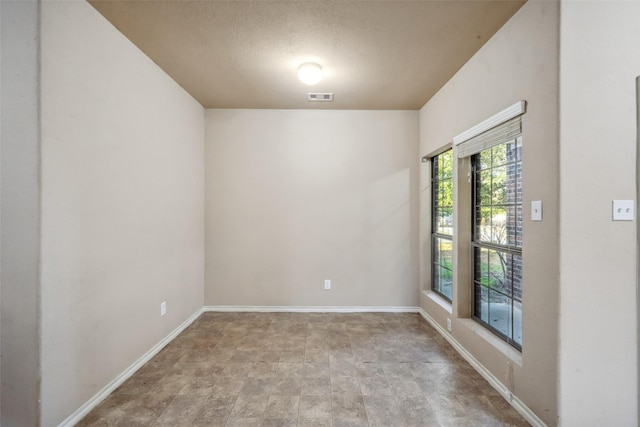 empty room with a textured ceiling