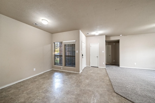 empty room with a textured ceiling