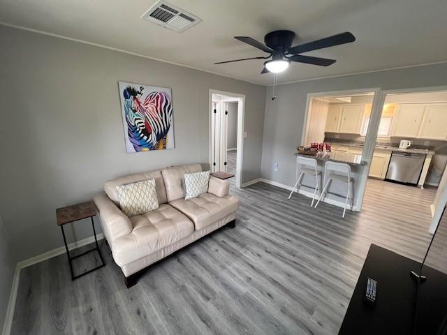 living room featuring hardwood / wood-style flooring and ceiling fan