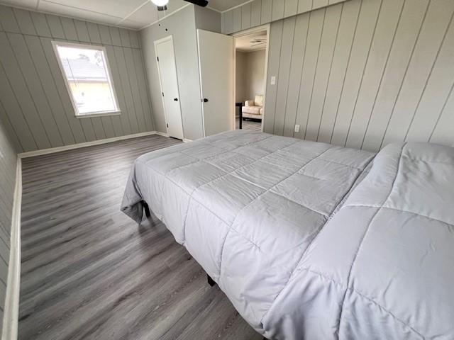 bedroom with ceiling fan and dark hardwood / wood-style flooring