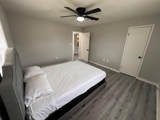 bedroom featuring ceiling fan and wood-type flooring