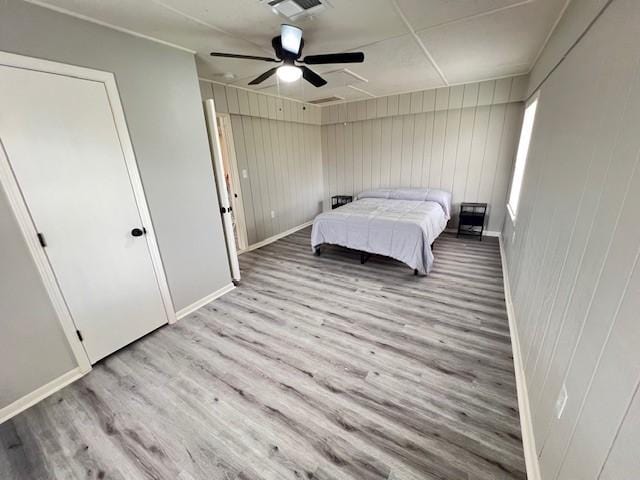 bedroom with ceiling fan and light wood-type flooring