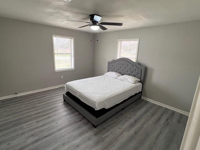 bedroom with dark wood-type flooring and ceiling fan