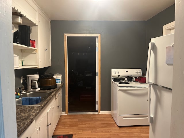 kitchen with sink, white appliances, light hardwood / wood-style flooring, and white cabinets