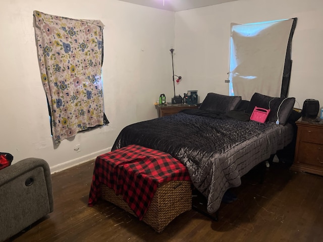 bedroom with dark wood-type flooring