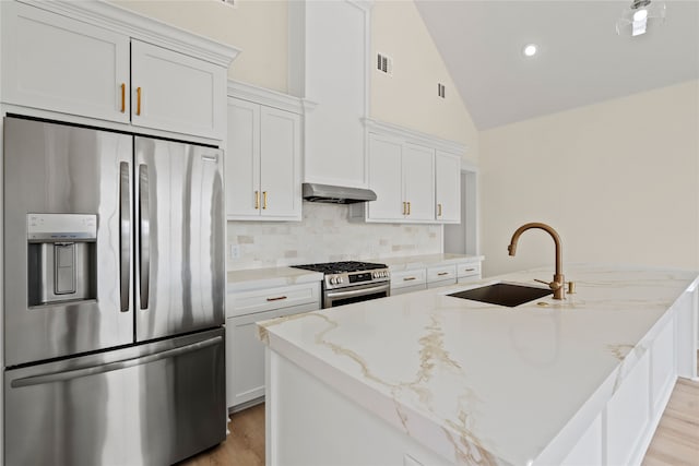 kitchen with white cabinetry, appliances with stainless steel finishes, sink, and light stone counters