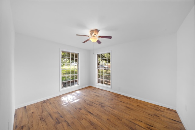 spare room with wood-type flooring and ceiling fan