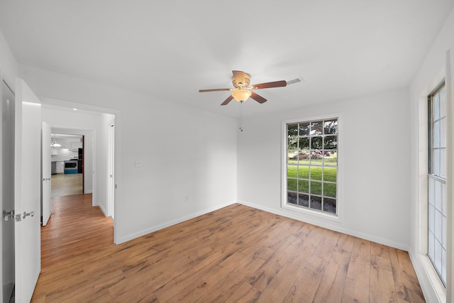 unfurnished room with light hardwood / wood-style flooring and ceiling fan