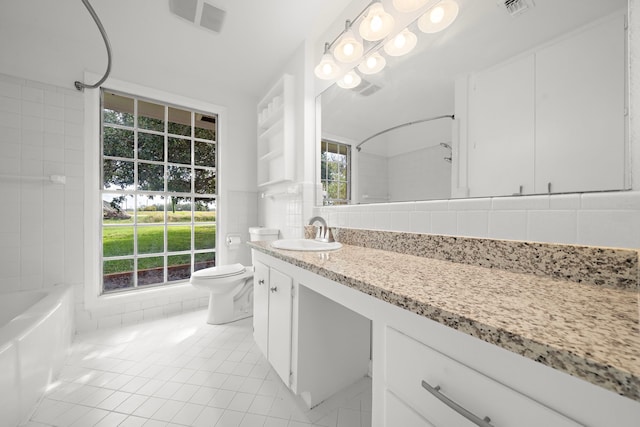 full bathroom with a wealth of natural light, backsplash, tile patterned flooring, vanity, and bathing tub / shower combination