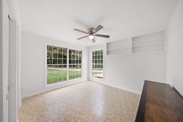 unfurnished room with ceiling fan