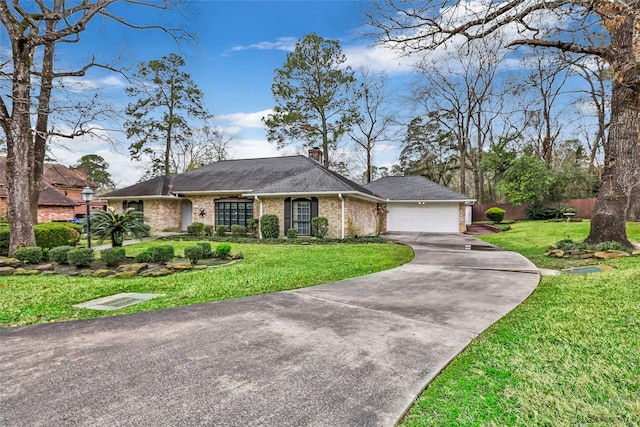 single story home featuring a garage and a front yard