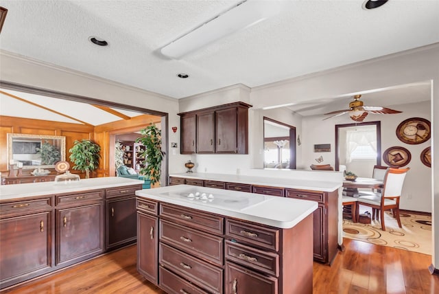 735 Angelina Dr, Conroe, TX 77302 - kitchen with light wood finished floors, a textured ceiling, a ceiling fan, and light countertops