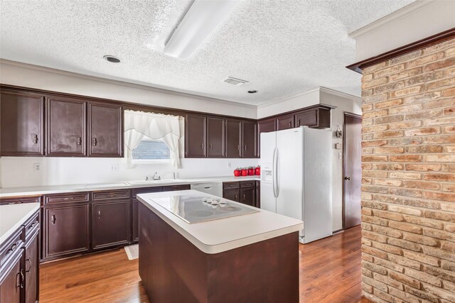 735 Angelina Dr, Conroe, TX 77302 - kitchen featuring dark brown cabinetry, a textured ceiling, wood finished floors, and white appliances