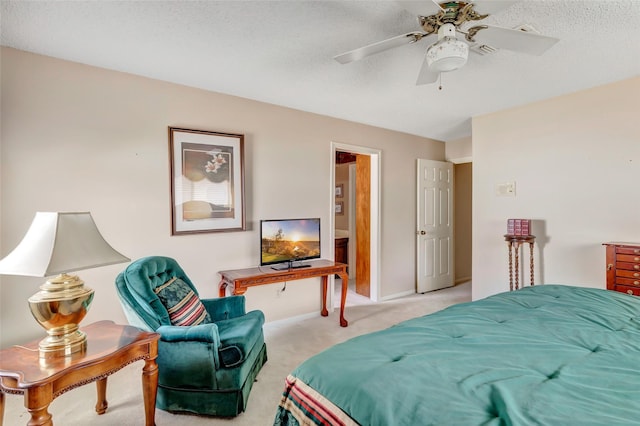 bedroom featuring ceiling fan, light colored carpet, and a textured ceiling