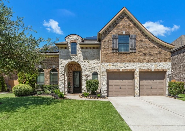 view of front of home featuring a garage and a front yard