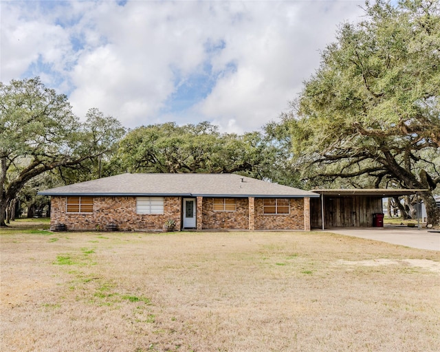 ranch-style home with a carport and a front yard