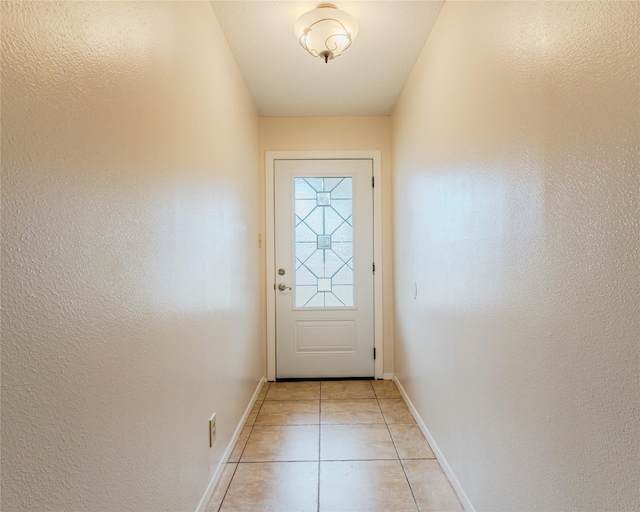 doorway with light tile patterned floors