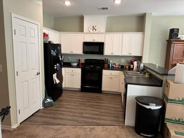 kitchen with white cabinetry, dark hardwood / wood-style floors, sink, and black appliances