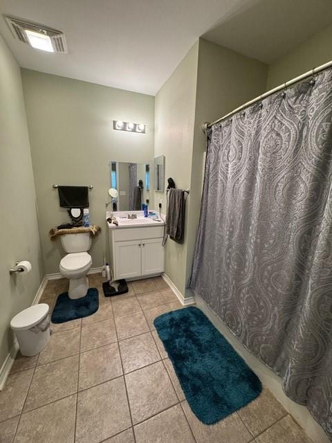 bathroom with tile patterned flooring, vanity, and toilet